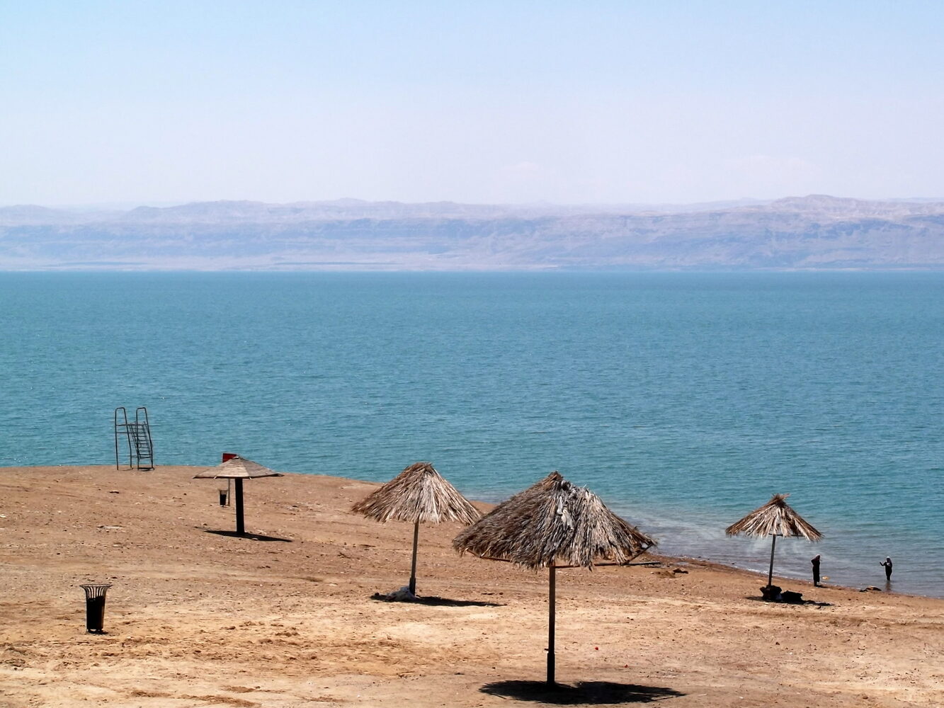 A visitor floating effortlessly in the mineral-rich waters of the Dead Sea