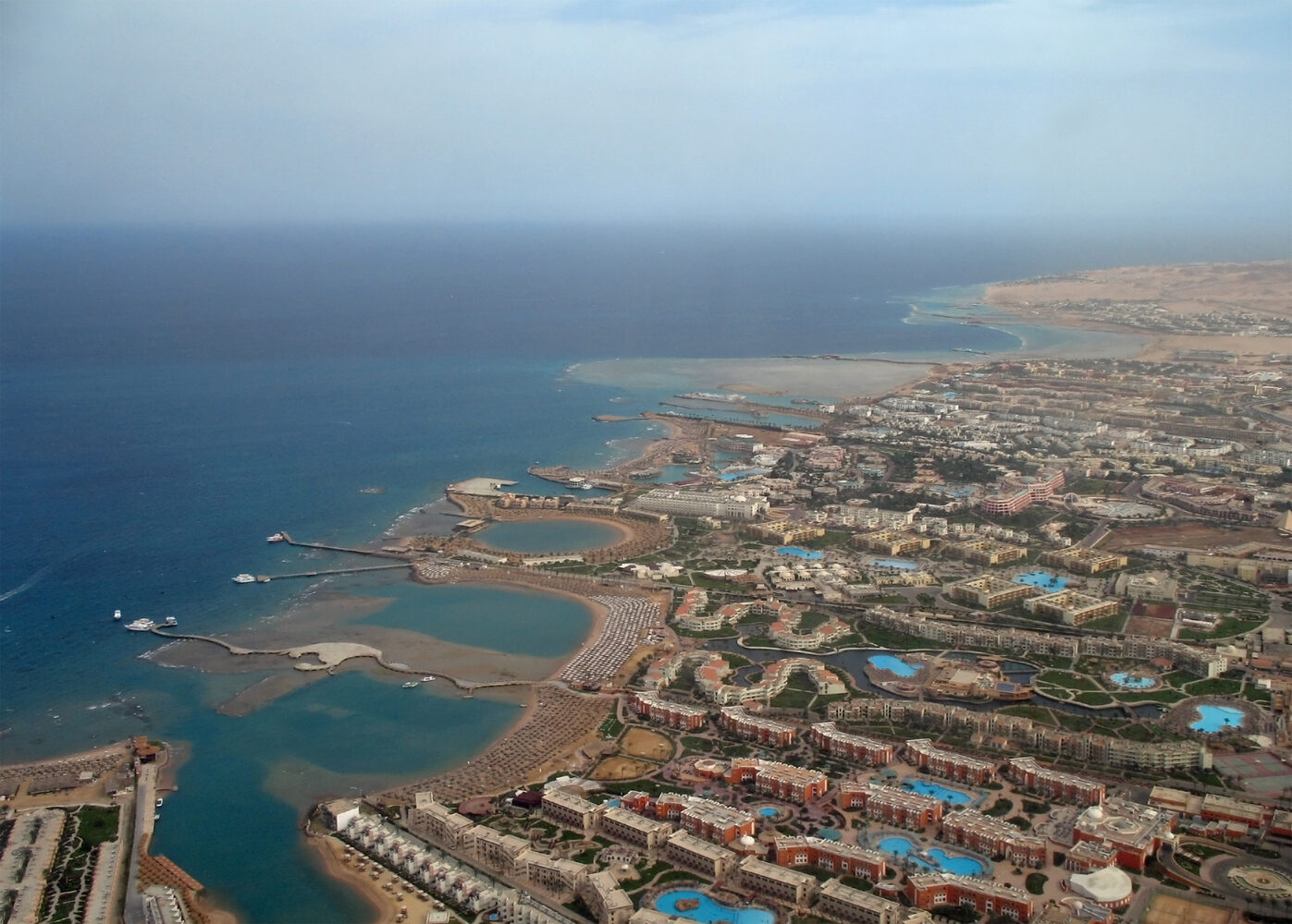 A resort beach with palm trees along the Red Sea coast in Hurghada