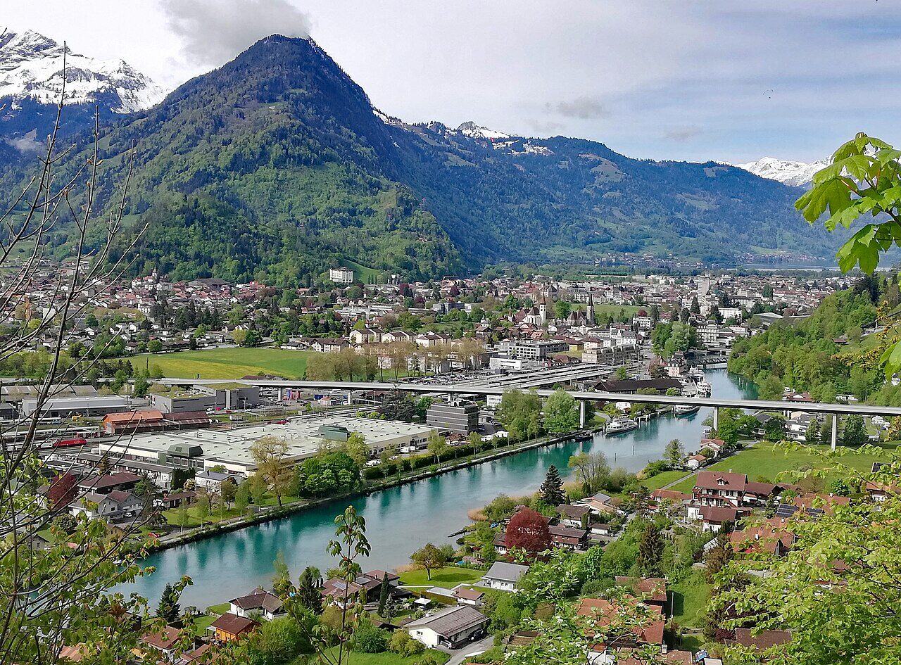 The alpine town of Interlaken with the Jungfrau massif rising above green meadows