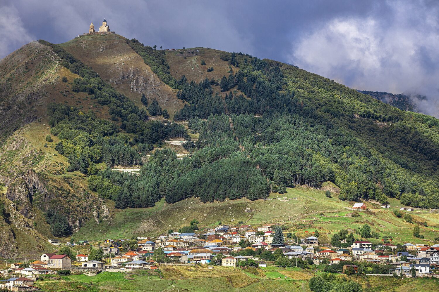 The Gergeti Trinity Church with snow-capped Mount Kazbek behind it
