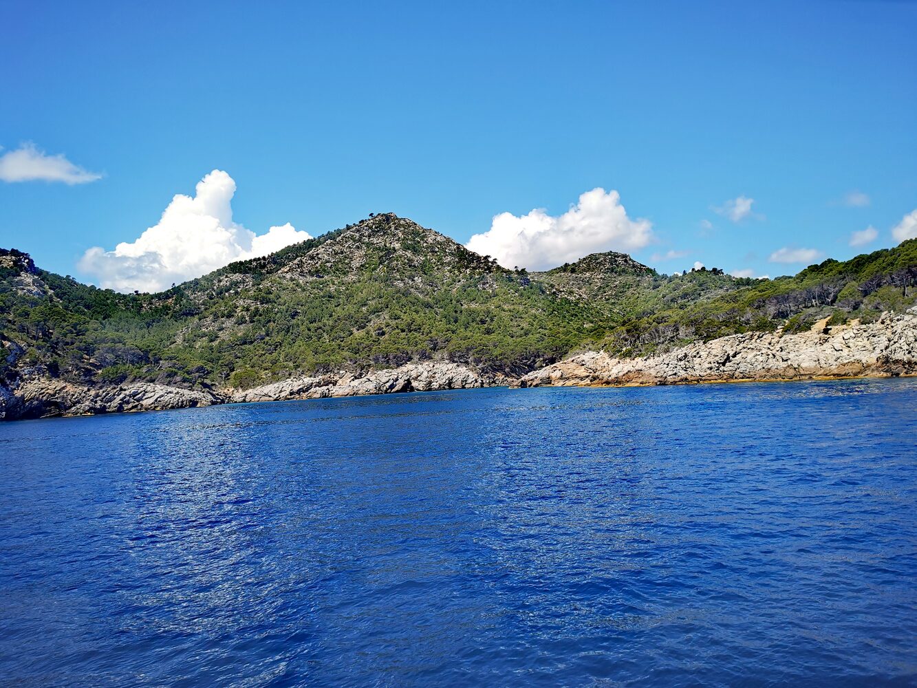 Crystal-clear turquoise coves and limestone cliffs along the Mallorcan coastline