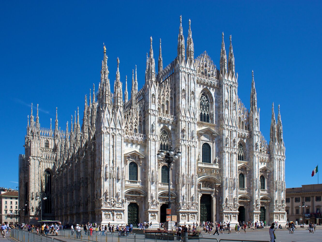 The ornate Gothic façade of Milan's Duomo cathedral rising over the city's central square